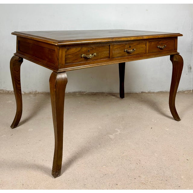 Elegant Spanish writing desk crafted in oak during the 1940s. The desk features a spacious rectangular top above three...