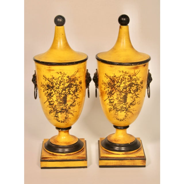 A stunning pair of vintage Italian yellow tole lidded urns. These vases are such a lovely color! The lions head ring...