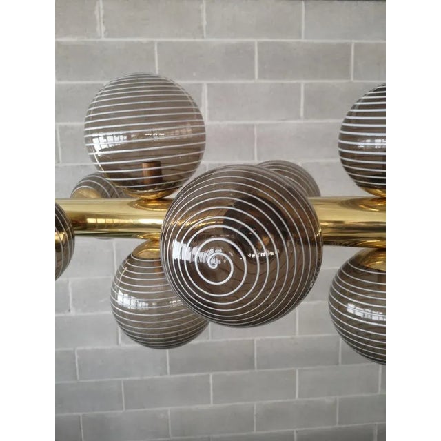 Characterized by simplicity and linearity Murano chandelier, its beautiful colors with more shades of brown color with...