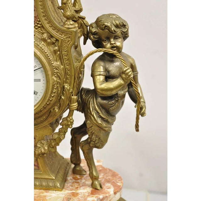 Vintage French Louis XV Style Brevetatto Italy Brass and Marble Figural Cherub Clock. Item features an ornate figural...