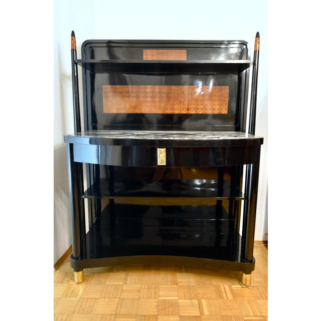 The buffet shown is one of Prof. Josef Hoffmann's signature furniture designs for the Viennese bentwood furniture company...