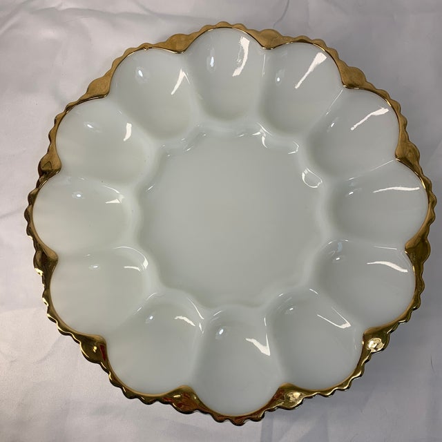 Offered here is this mid century vintage white opalescent milk glass deviled egg plate with 22k gilt edge. Item is in...