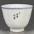 A charming Chinese porcelain tea cup. The exterior is finely hand-painted in vibrant Famille Rose enamels, featuring two...