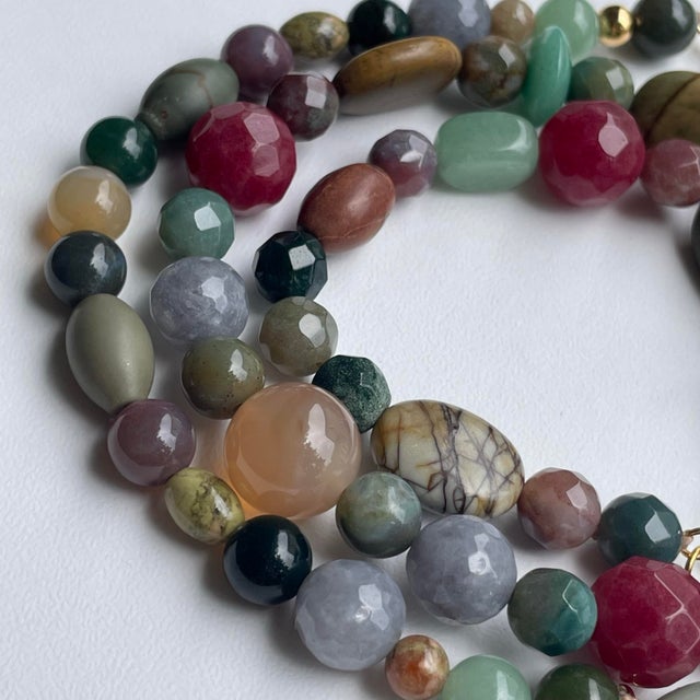 An eclectic, multi-color necklace and bracelet set with semi-precious gemstone beads finished with 14k gold-filled (GF)...