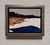 This oil painting captures a serene coastal landscape, where deep blue waters meet a sandy shore under a muted sky. The...