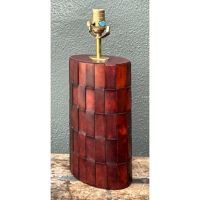This vintage woven leather lamp brings tactile texture and warm, earthy character to a room. Its cylindrical shade is...
