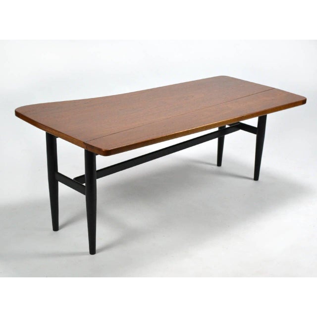 This terrific example of Finn Juhl's unique aesthetic is also a highly functional and versatile table. The walnut top has...