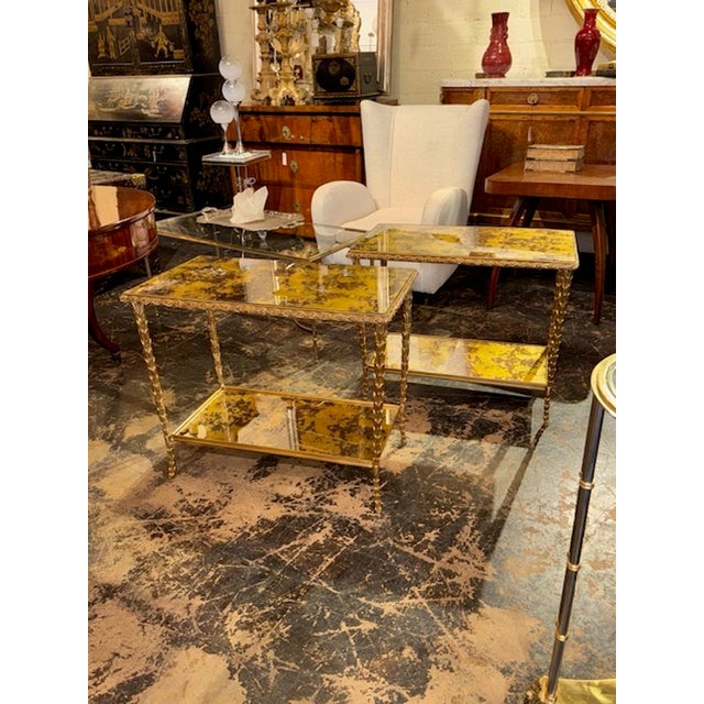 The product is a pair of Italian Maison Bagues Manner gilt bronze side tables. The tables are crafted with intricate gilt...