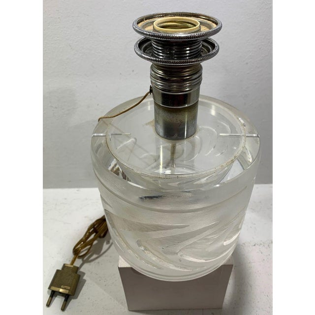 Lamp stand in glass signed at the base Lalique France. 12 cm H glass and 21 cm H with lamp holder. René Jules Lalique...