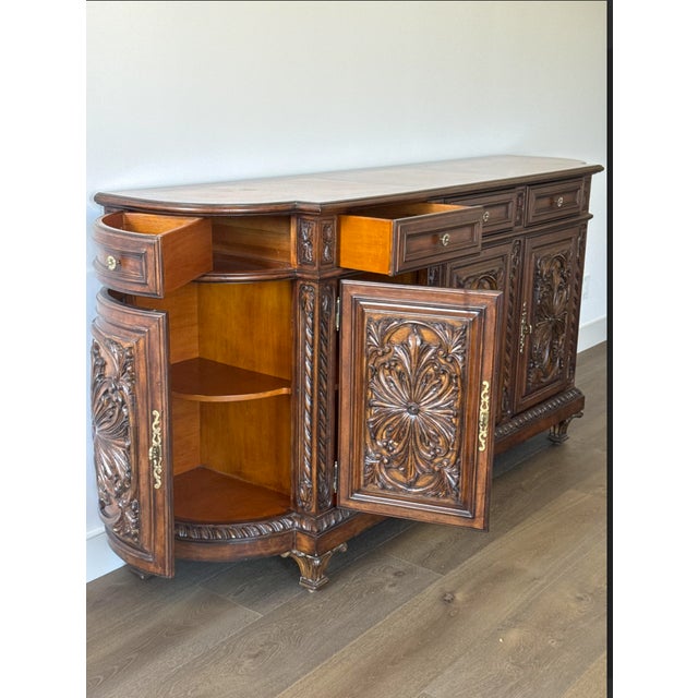 Stunning large credenza/buffet sideboard featuring intricate hand-carved floral medallion panels on every door. This...