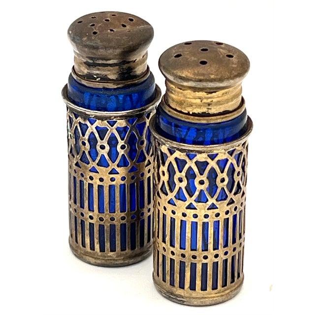 Small, made of cobalt blue glass with silver-plated openwork metal, dating to circa 1900–1925. It is valued for its...