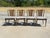 Elegant set of four cherrywood caned back dining chairs with brass sabots and brass crest rail. All of the metal pieces...