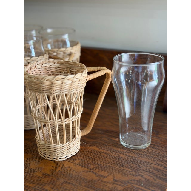 Add a touch of coastal Grandmillenial vibes to your barware collection with this stylish set of eight rattan-wrapped...