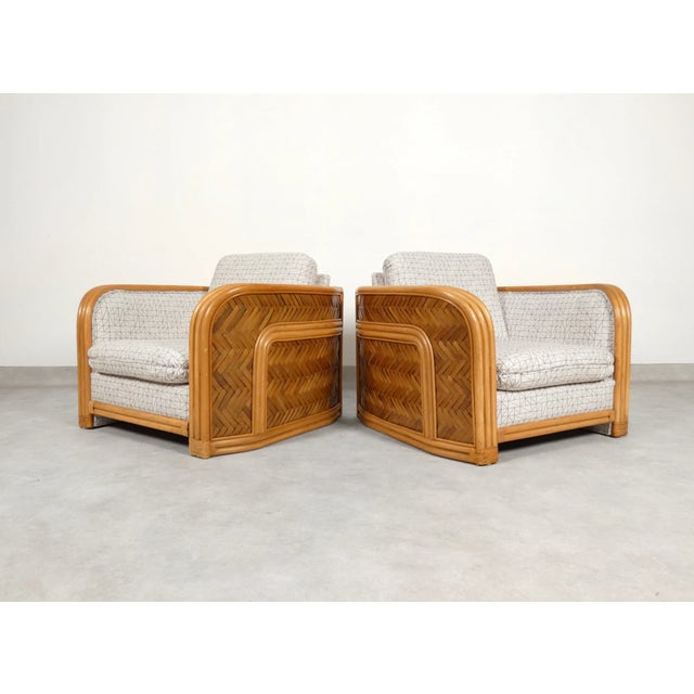 Beautiful pair of fauteuils made of bamboo and ratten and finished with a graphic pattern fabric. The back of the chairs...