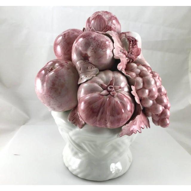 Purchased from an estate sale is this beautiful ceramic basket of fruit that was hand made and painted in shades of pink....