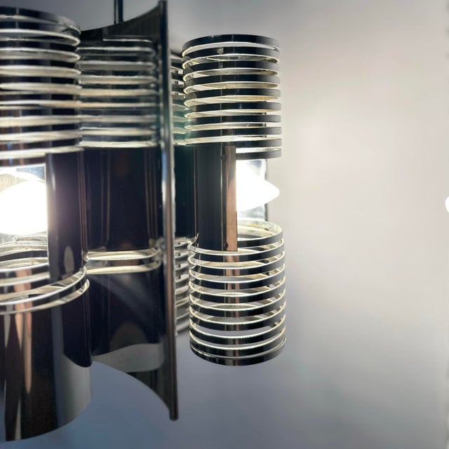 This is a striking original 1970s Italian pendant lamp with the typical space-age lighting design. This sculptural chrome...