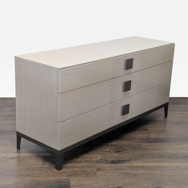 This Alf + DaFre dresser features a sleek, modern design with a light wood finish. It offers three spacious drawers with...