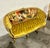 An extraordinary French statement sofa, fully restored with genuine 24K gold leaf and upholstered in rich mustard fabric....