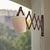 Vintage wooden scissor wall lamp featuring an adjustable accordion-style extension arm. The articulated wooden mechanism...