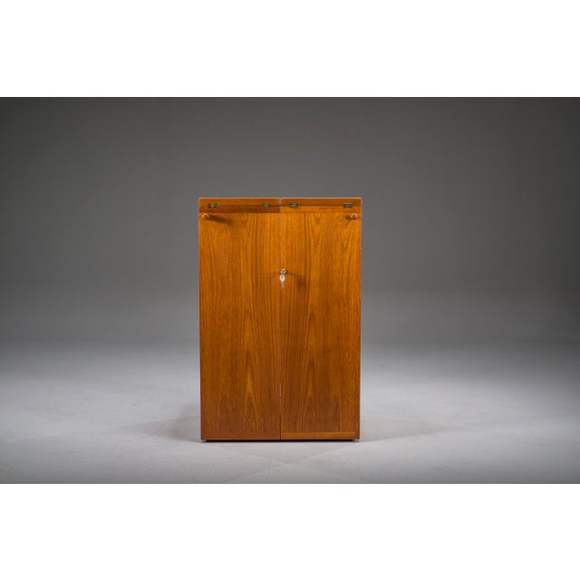 An elegant Danish Modern teak bar cabinet designed by Reno Wahl Iversen for Dyrlund in the 1960s. Crafted from beautifully...