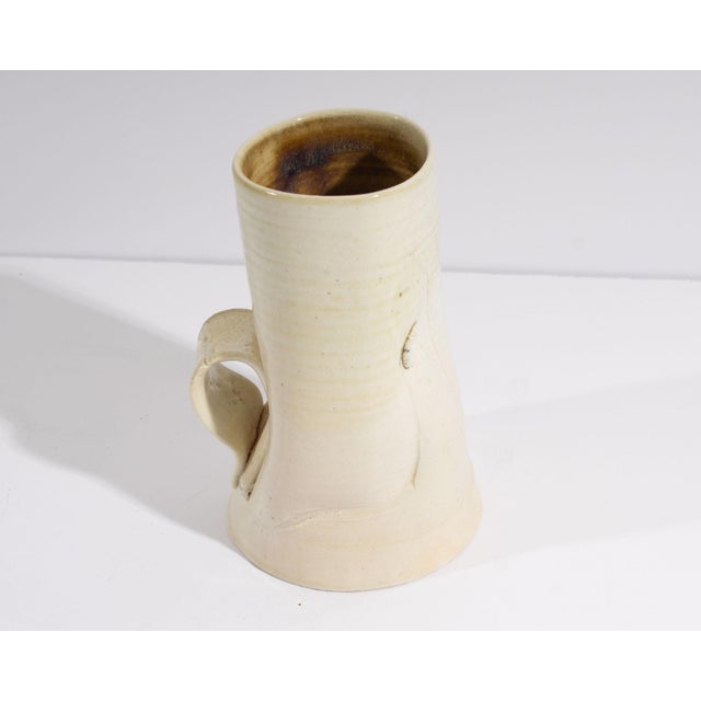 Two mugs by the American artist June Skowronski Onesti (1940-2022). Both signed with Onesti's cipher to the underside, the...