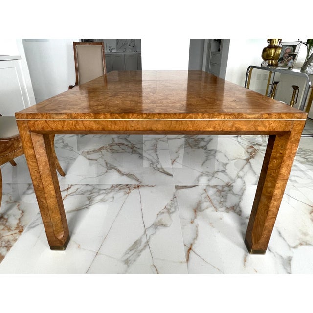 A just gorgeous Mid-Century Hollywood Regency dining table by Mastercraft, in burled wood with brass detailing. This...