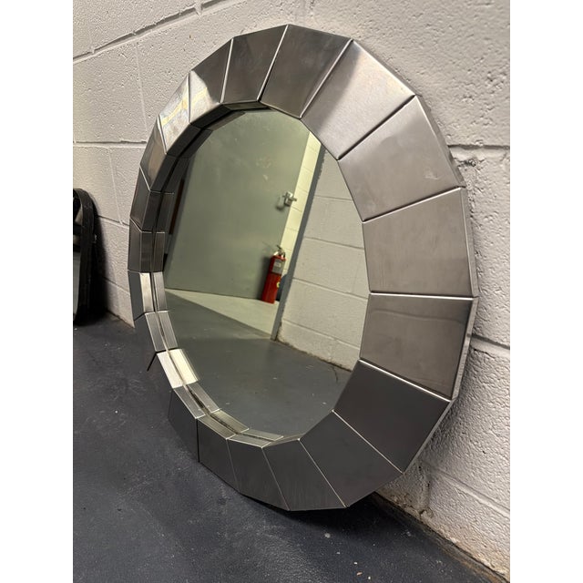1970s pair of round polished steel framed mirrors. Great condition with small, light scratching on one of the mirrors.