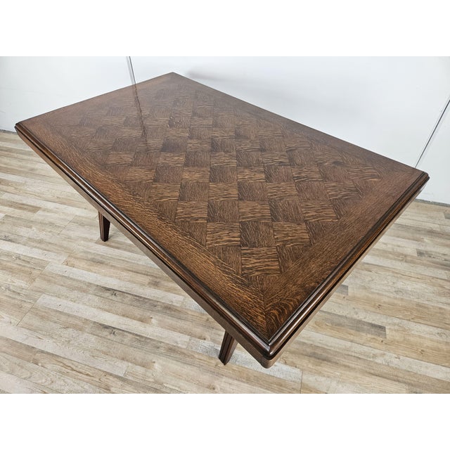 A 1950s oak table with softwood side extensions. It's distinctive for its geometric surface and compact dimensions, making...