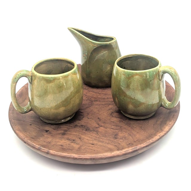 Offered is a set of handcrafted studio pottery pieces signed "Kathy 1969" that consists of a creamer and two coffee or tea...