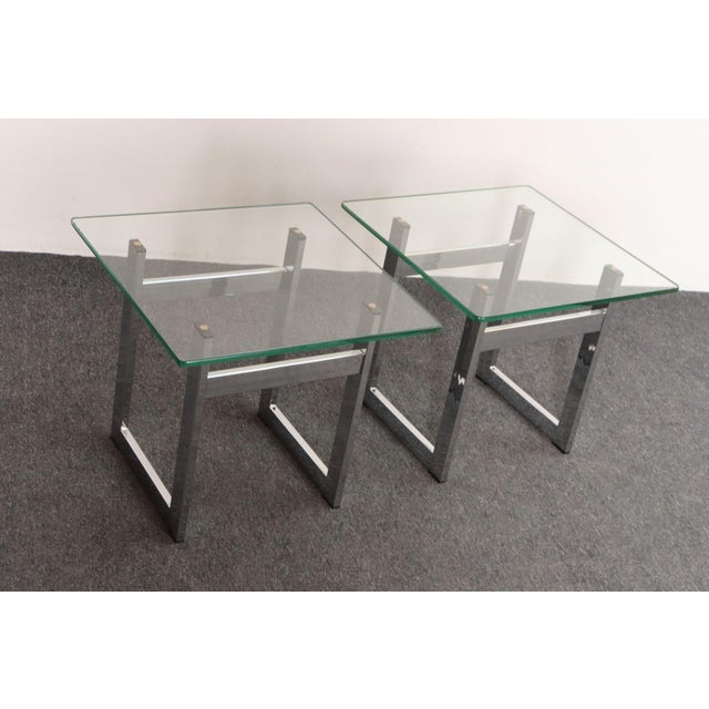 Pair of polished chrome side/end tables with square glass tops (ca. 1960s, USA). Although, this design is often attributed...