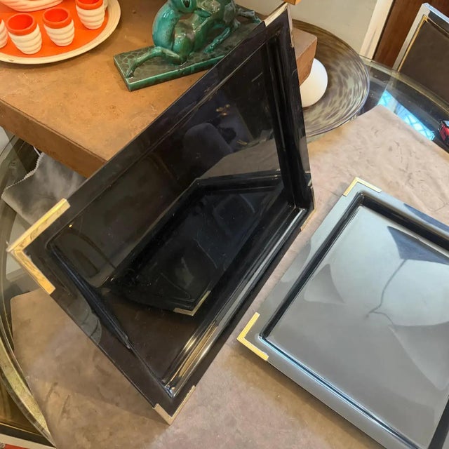 This sophisticated set of two mid-century modern barware trays from the 1970s effortlessly captures the glamorous, high-...