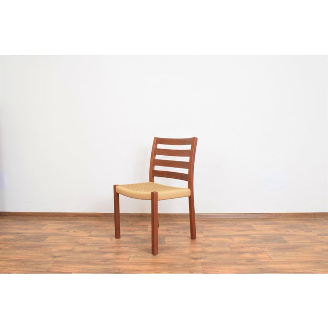 This dining chair was designed in the 1960s by Niels O. Møller for J.L. Møllers. Wooden elements made of solid teak have...