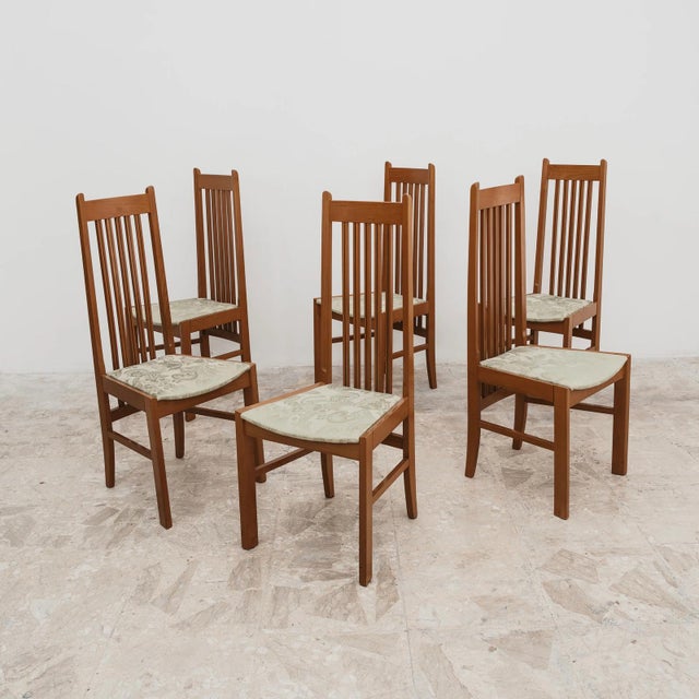 An elegant and minimalist set of six vintage dining chairs, inspired by scandinavian craftsmanship from the late 20th...