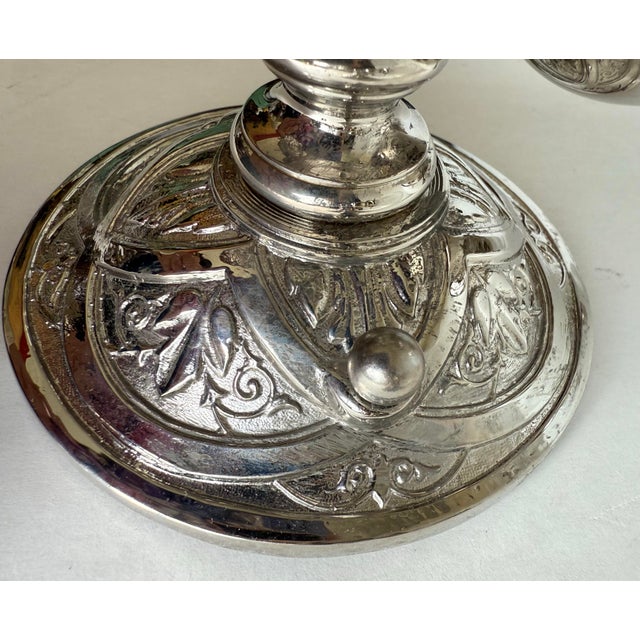 This pair of hardwired bathroom wall sconces dates to the late 20th to early 21st century and features a refined Art...