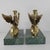 These brass griffin bookends, with elegant wings and fierce expressions, rest on green marble bases. They provide...