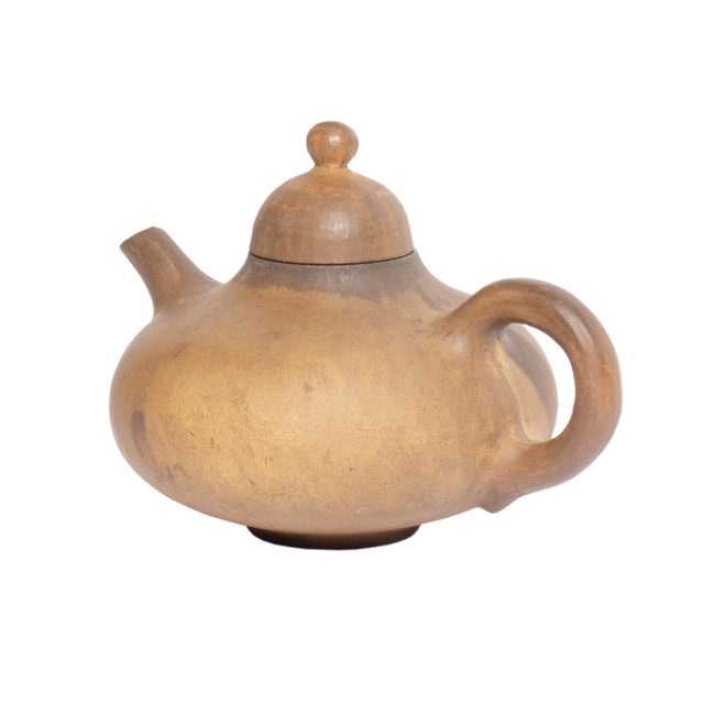A 1951 ceramic teapot designed by the Danish designer Jørgen Møller-Petersen. Brown in color, this teapot has a short...