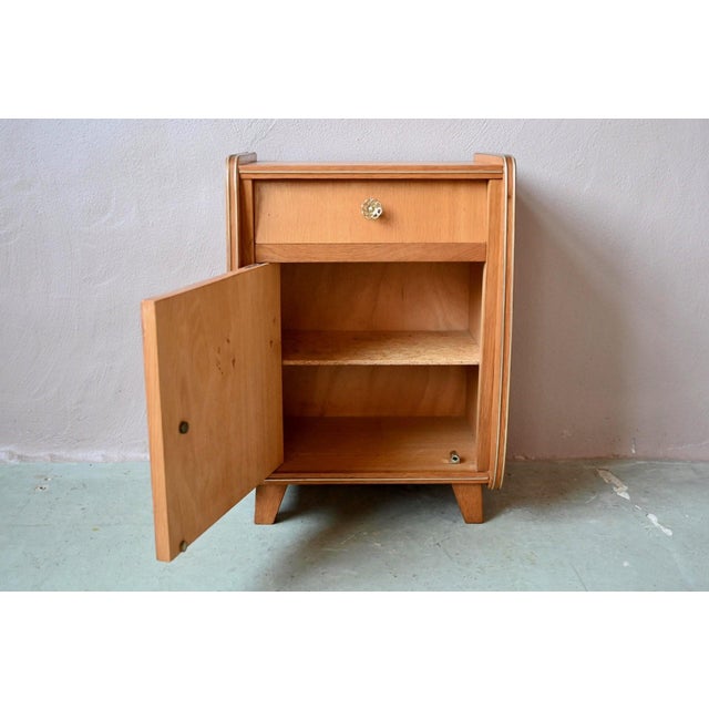 Here's a retro bedside table from the 1960s with charming details! with its slanted drawer front, rounded sides, and...