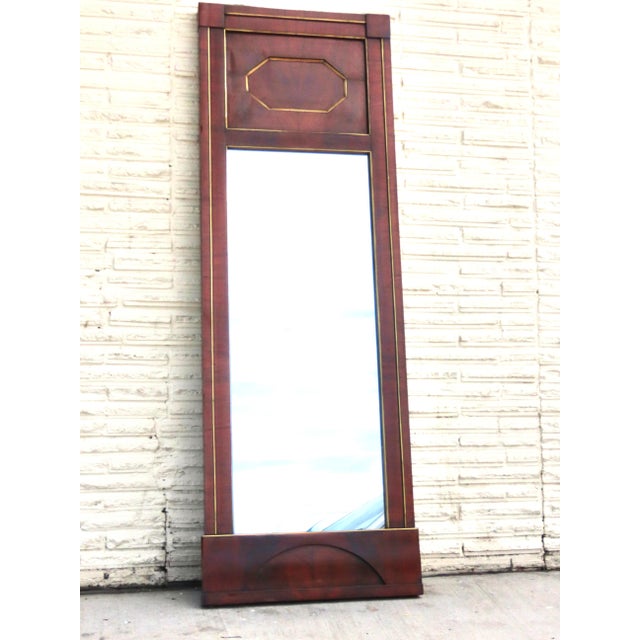 French Empire mahogany pier mirror. Brass inlaid molding outlines mirror plate, side columns and octagonal inset panel....
