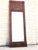 French Empire mahogany pier mirror. Brass inlaid molding outlines mirror plate, side columns and octagonal inset panel....