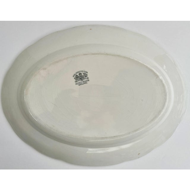 This white-on-white embossed pattern with a simple raised border has a few shafts of wheat and flowers and was made in the...