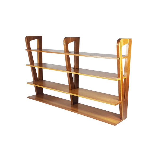 This hanging shelf was produced in Italy around the 1950s. It is made from teakwood and remains in overall good condition....
