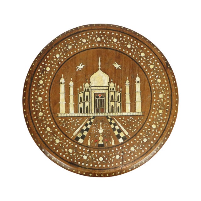 Beautiful mid-century Anglo-Indian side table with legs shaped like elephant heads and a round tabletop featuring an image...