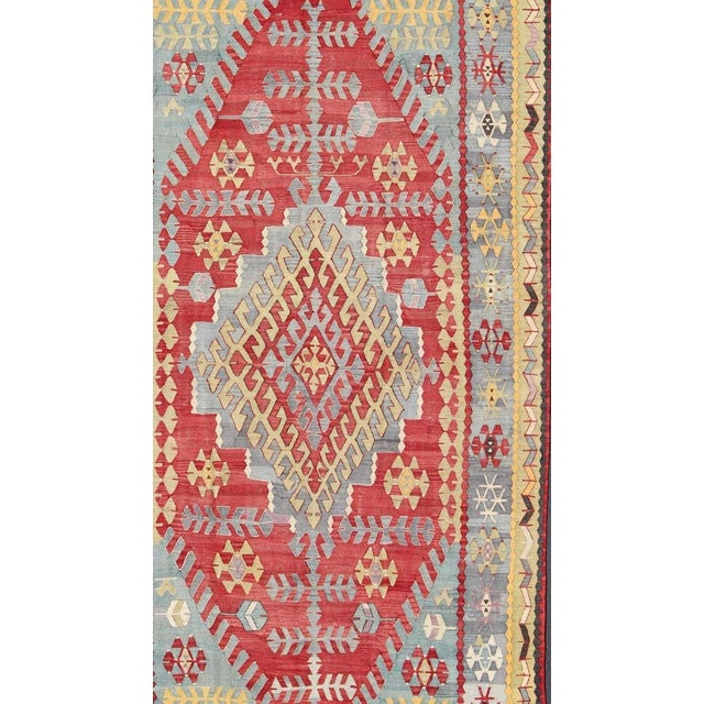 Vintage Turkish Kilim flat-weave rug with geometric design in red, light blue, yellow, green, rug , country of origin /...