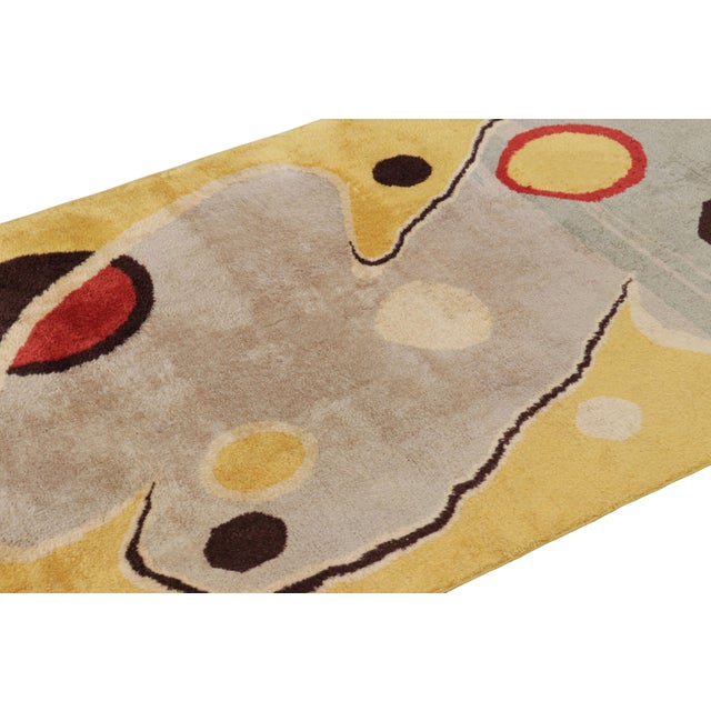 Made with hand-knotted wool circa 1960-1970, this 4x7 vintage rug from Turkey is believed to be the work of mid-century...
