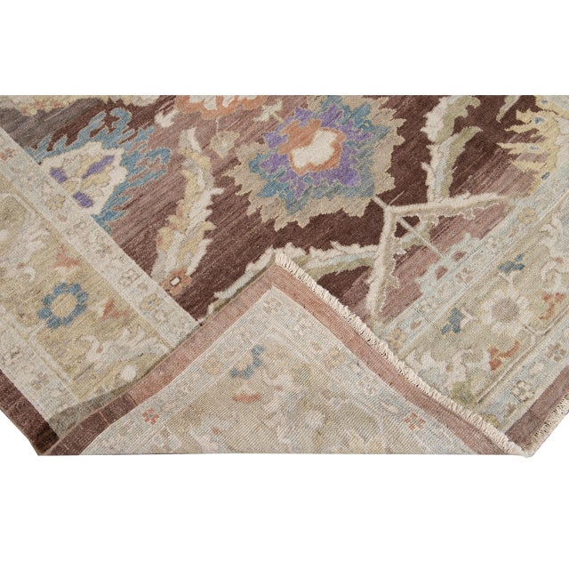 Beautiful Modern Sultanabad hand-knotted wool rug with a brown field. This Sultanabad rug has a beige frame and a multi-...