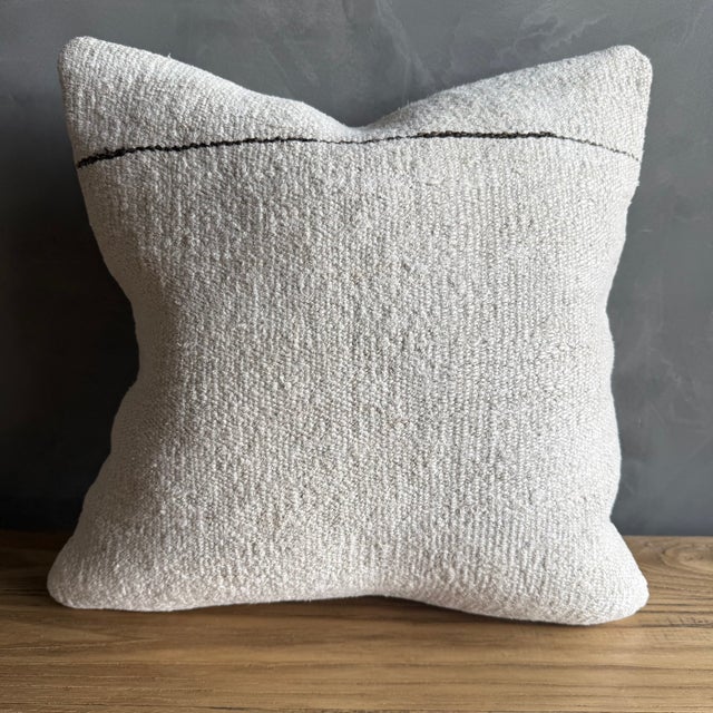 Creamy white hemp rug pillow with original seams. Soft hand, linen blend backing with zipper closure. Spot cleaning is...