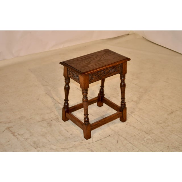 19th century oak joint stool from England. The top is wonderfully figured and has a beveled edge, following down to a hand...