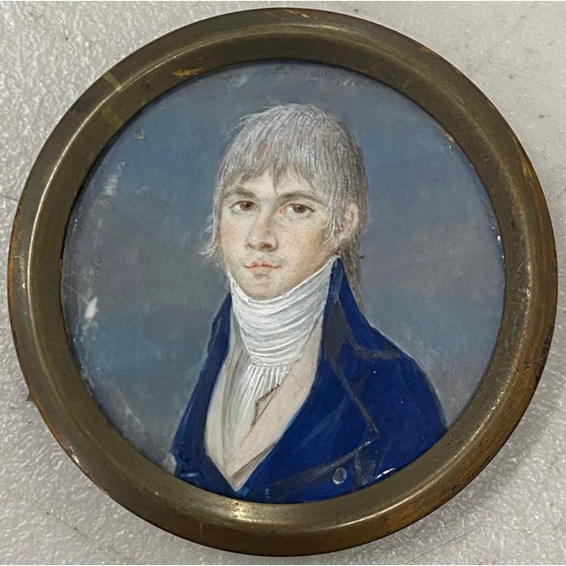 19th Century Portrait Miniature of a Young Man Wearing a Cravat A handsome young man with straight blonde hair. He wears a...