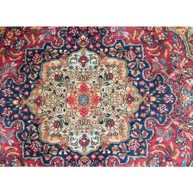 A beautiful early 20th century American Karastan-style rug with a large central floral medallion with even more floral...