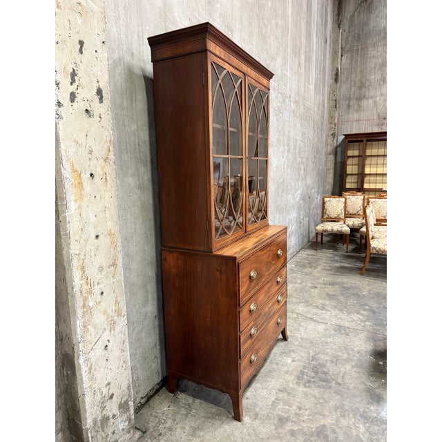 George III mahogany secretary bookcase, dating to the late 18th or early 19th century. The upper cabinet features two...